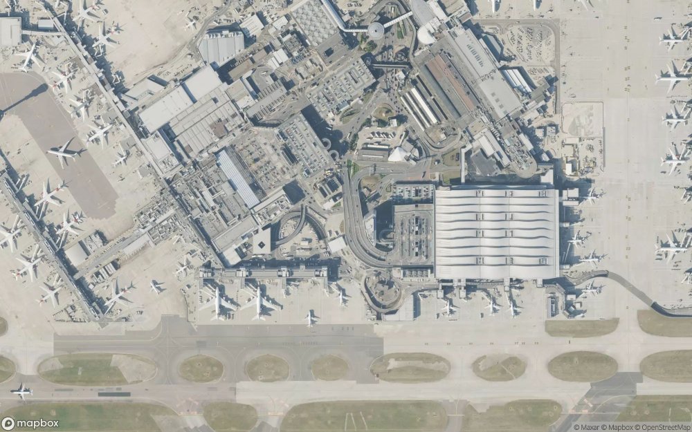 Major international airport from satellite showing multiple parallel runways extensive terminal complex and connecting taxiways